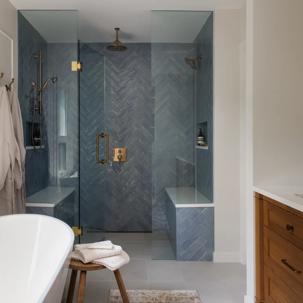 Ensuite with blue herringbone tile walk-in shower, brass fixtures and freestanding tub, 10 Mile Point renovation by Maverick Design, Victoria BC
