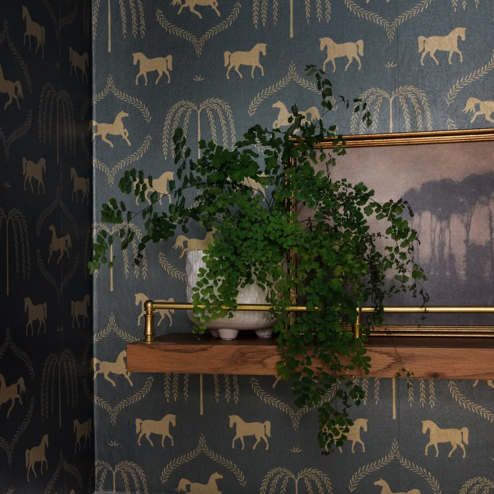 Powder room detail with navy and gold equestrian wallpaper and oak shelf with brass rail, 10 Mile Point renovation by Maverick Design, Victoria BC